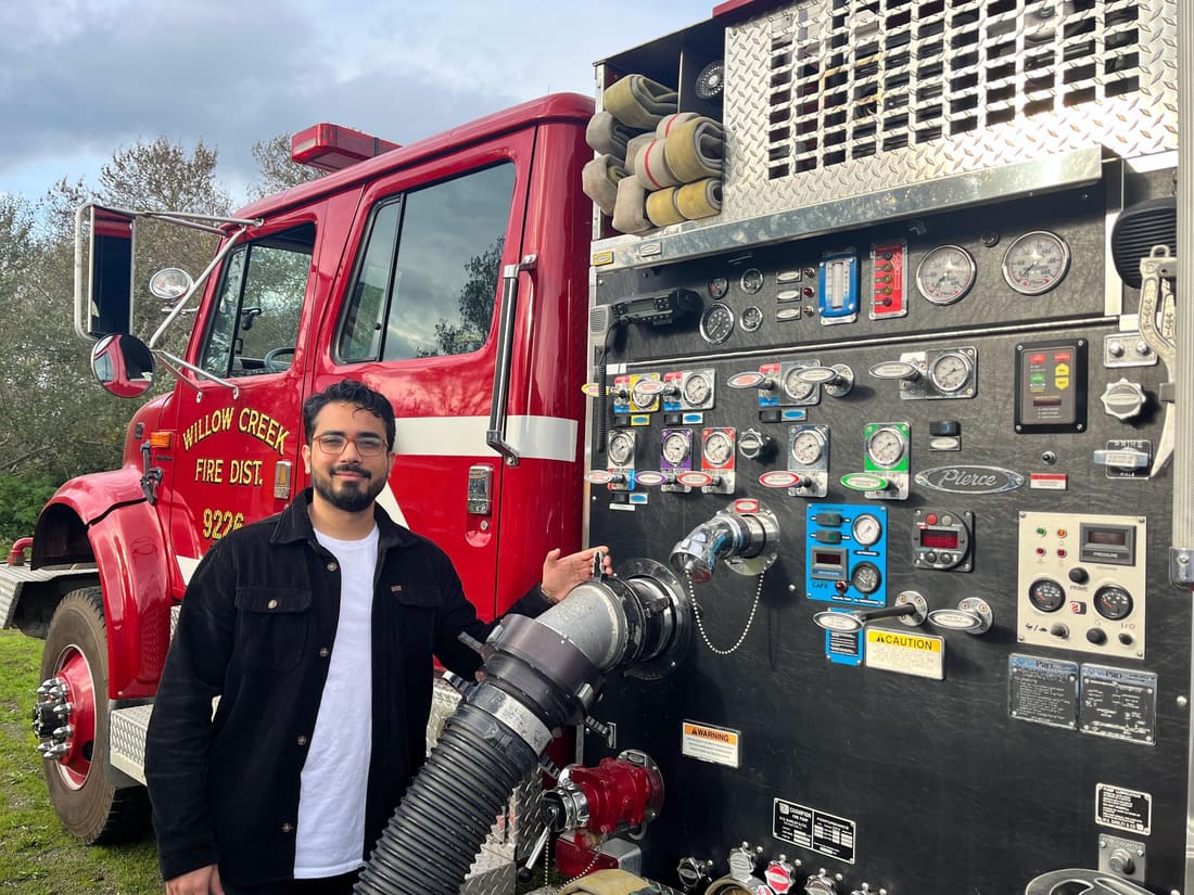 Rameez Hasan in front of a fire engine pump panel